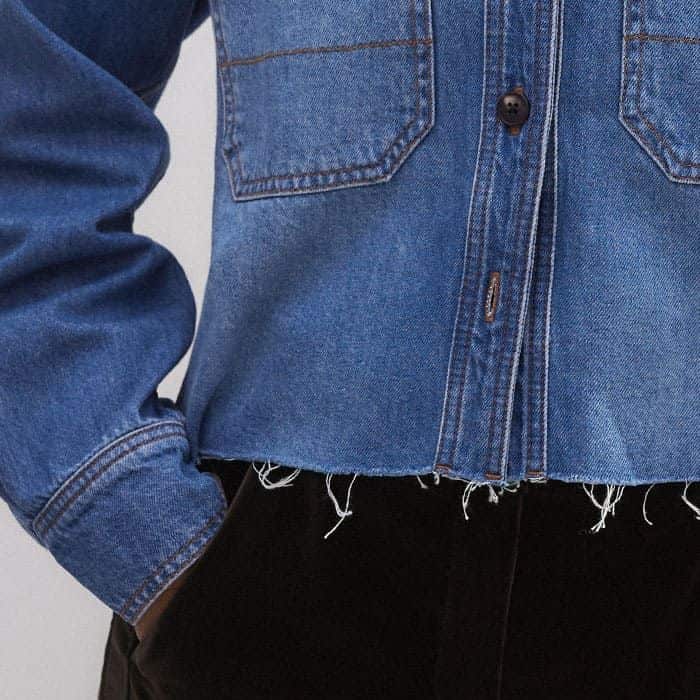 For an authentic finish, the piece falls to a frayed, cropped hem.