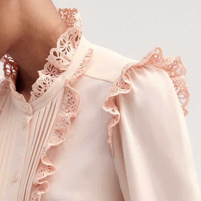 Broderie ruffled trims decorate the cuffs, shoulders, neckline and the pintuck front panel for an elevated finish.