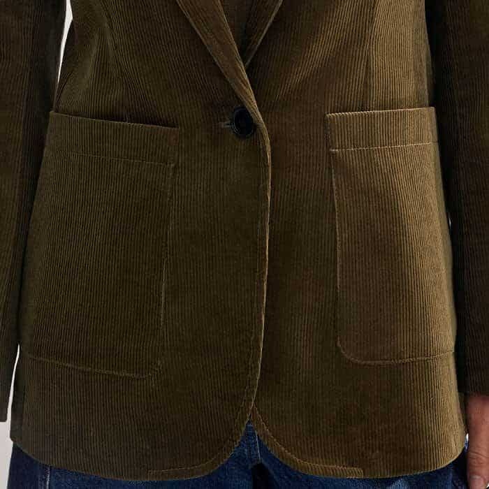 Deep patch pockets either side of the button-down front add functionality to the piece.