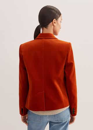 Made from a soft Italian cotton velvet in a bold orange hue.