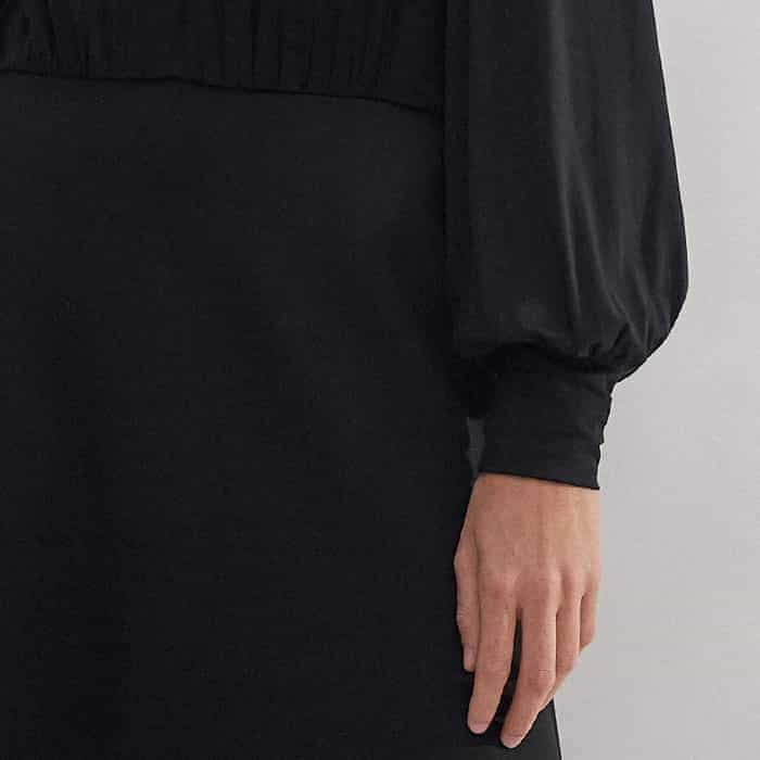 The sleeves fall to fitted cuffs to maintain a voluminous shape.