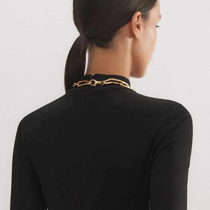 The zip is positioned at the back of the piece to keep the front free from detailing.