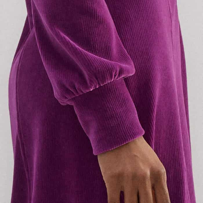 The sleeves fall to fitted cuffs to retain a polished finish.