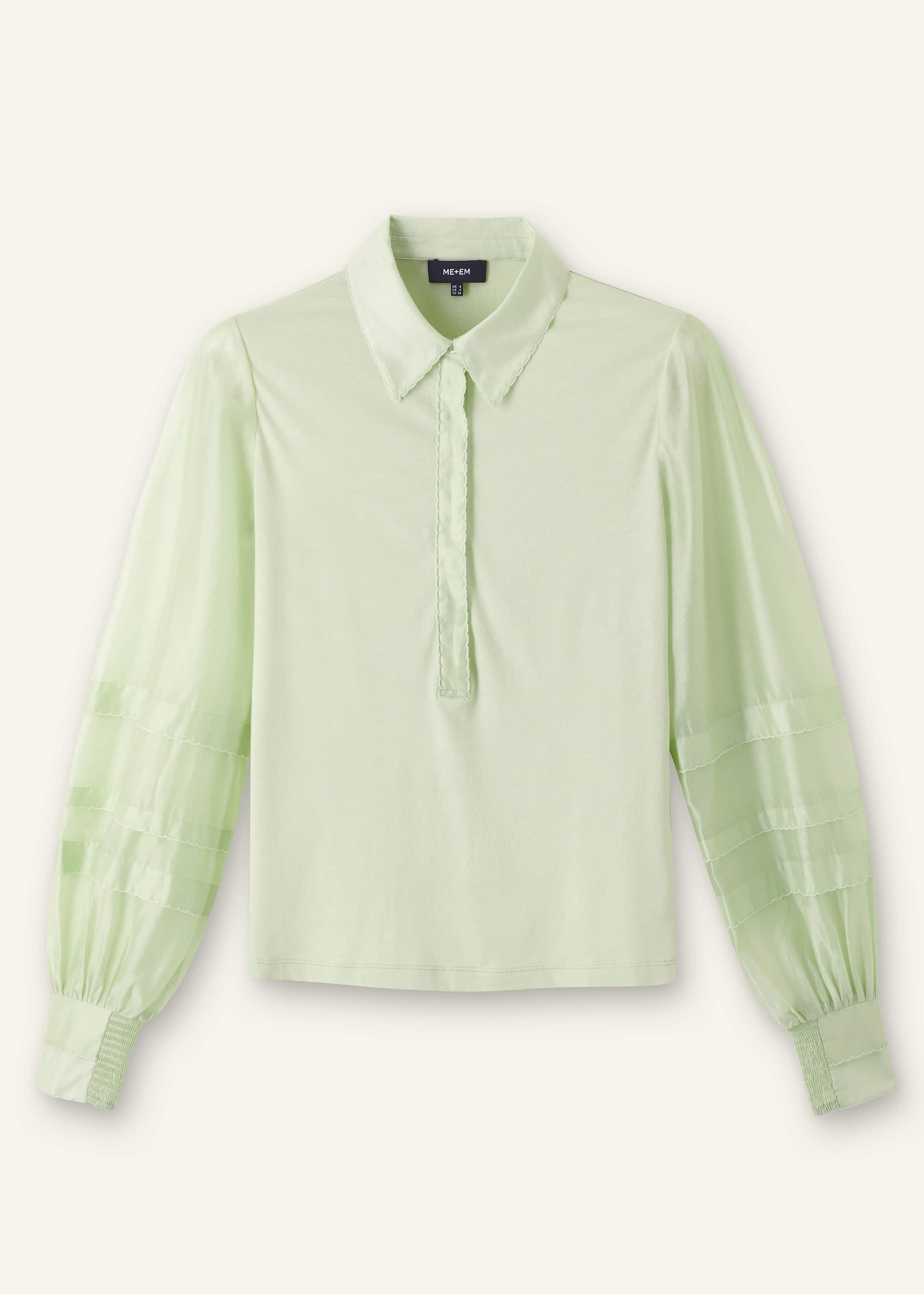 Crafted from soft jersey with contrasting sheer woven sleeves that have a subtle sheen.