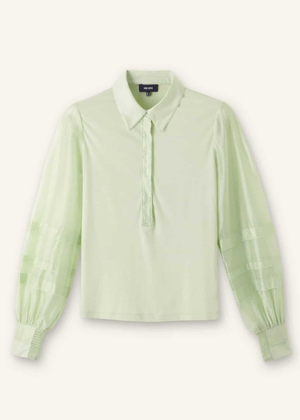 Crafted from soft jersey with contrasting sheer woven sleeves that have a subtle sheen.