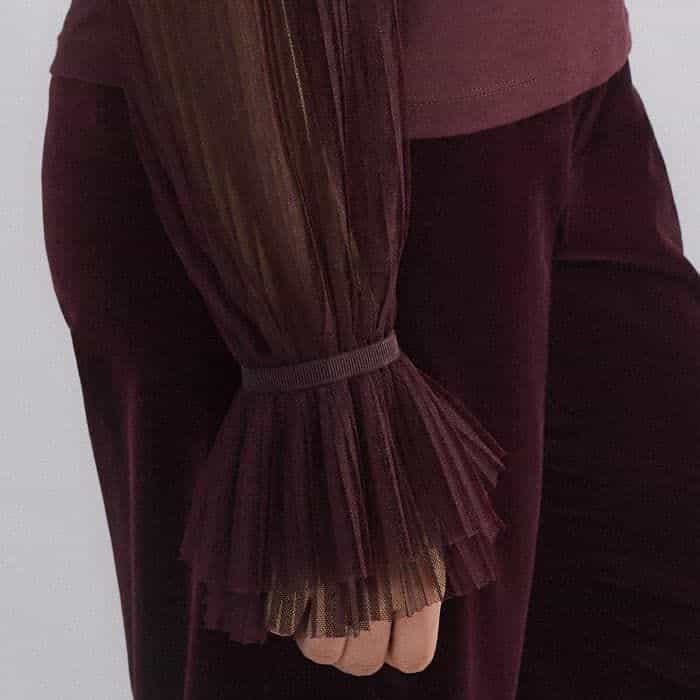 The sheer sleeves fall to flared elasticated cuffs which keep pushed-up sleeves in place.