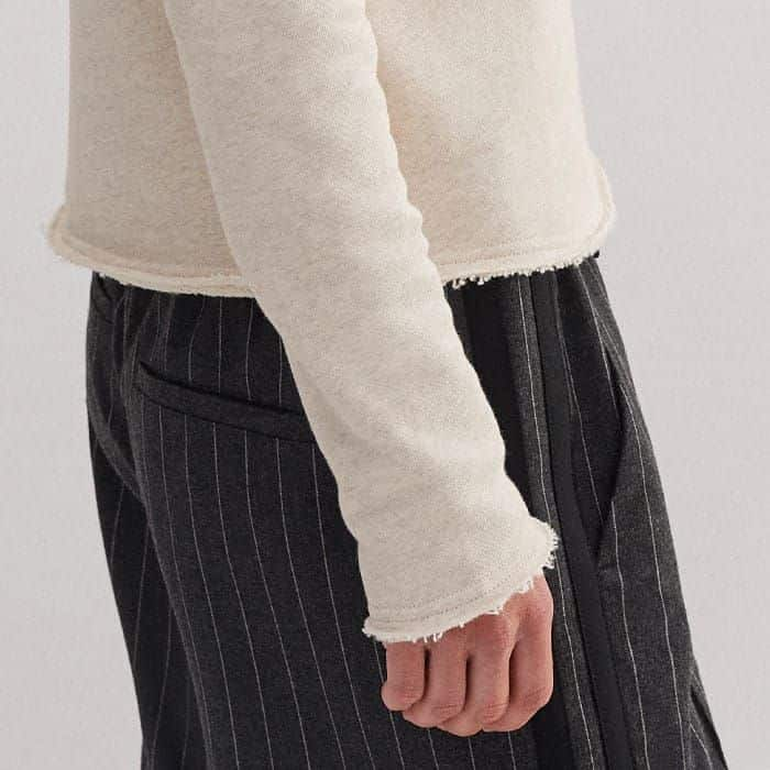 The hem and cuffs are signed off with a raw trim for an off-duty edge.