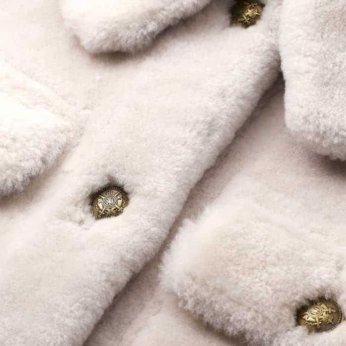 Crafted from ultra-soft by-product shearling with Italian buttons.