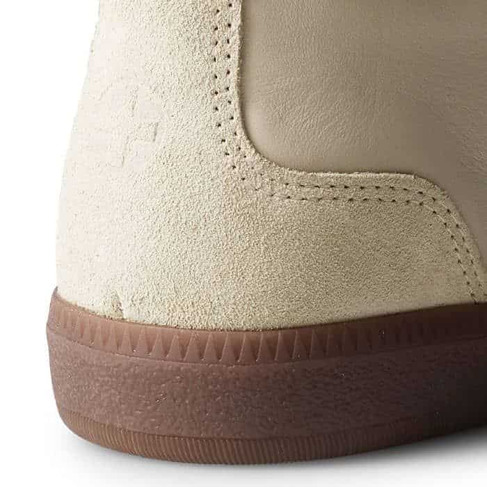 A heat-embossed cross is placed at the heel to subtly allude to our branding.