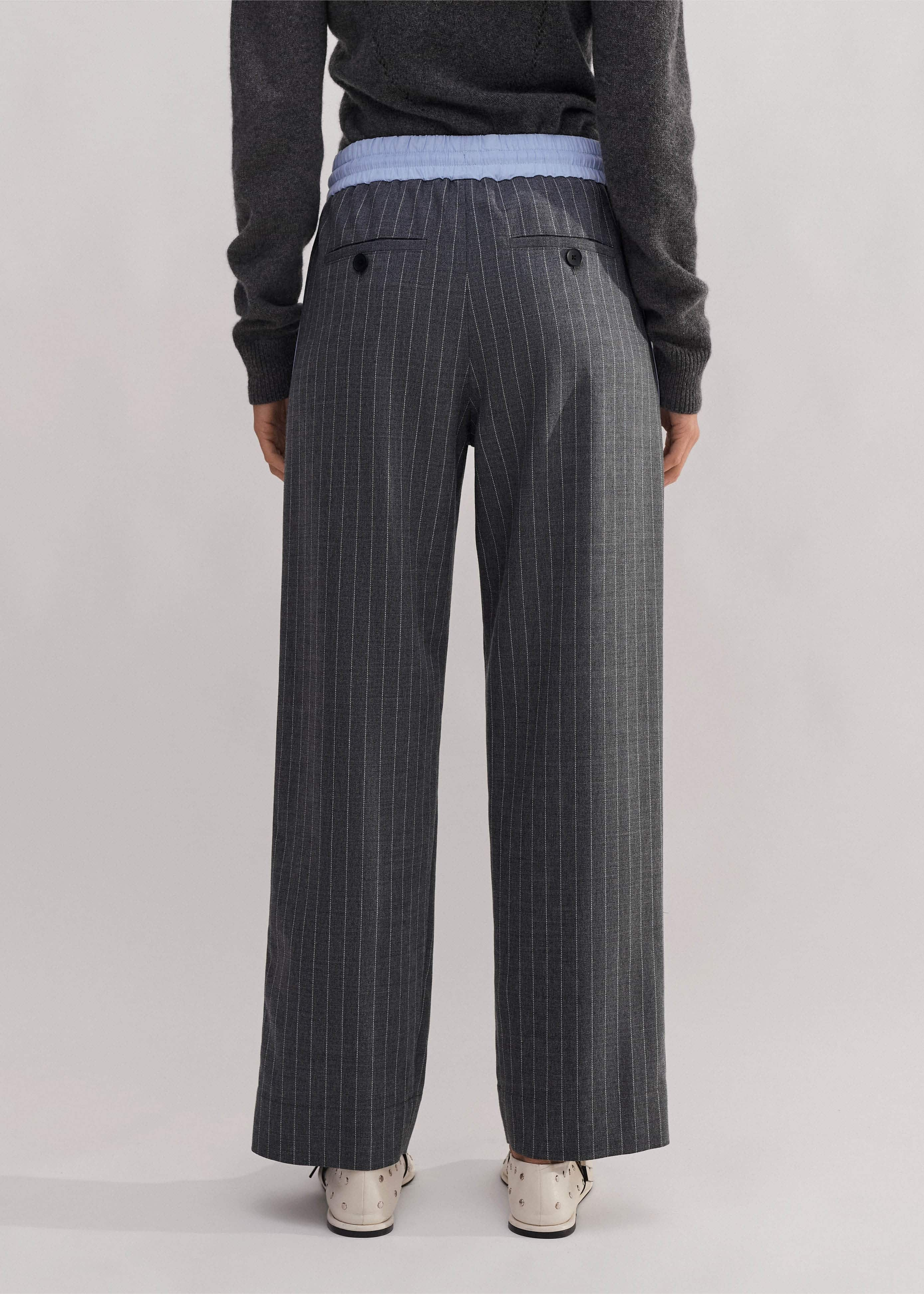 Made from an Italian wool blend fabric in a pinstripe pattern.