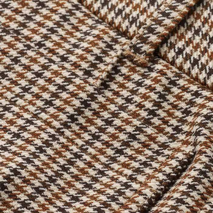 Crafted from a stretch-infused wool blend, patterned with a neutral-toned houndstooth check.