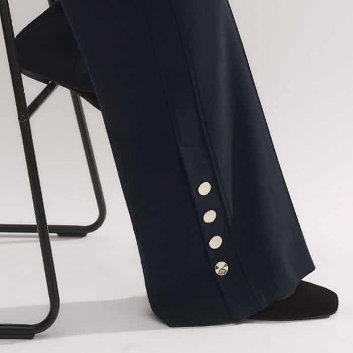 The cuffs are signed off with gold-toned buttons which can be left undone to create a wide-leg finish.