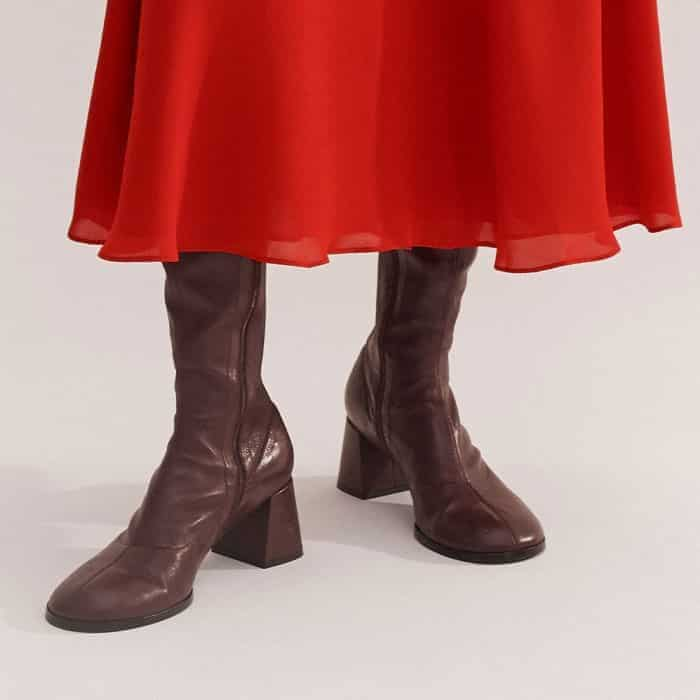 Complement the bold shade and midi length with our rich Oxblood Stretch Knee-High Boot.