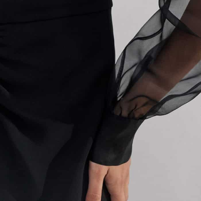 The sleeves fall to fitted cuffs to maintain their shape.