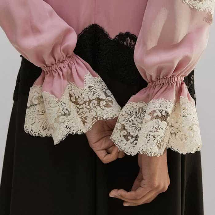 The sleeves fall to flared elasticated cuffs, signed off with a lace trim.