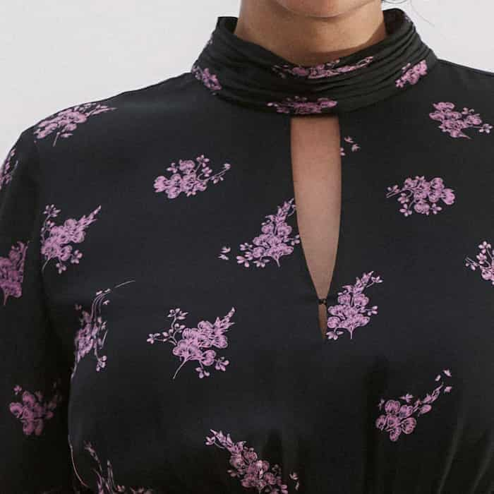 The neckline features two hook-and-eye fastenings to adjust the amount of coverage.