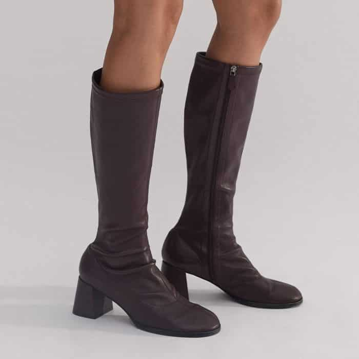 Our Stretch Knee-High Boot complements the shorter hemline.