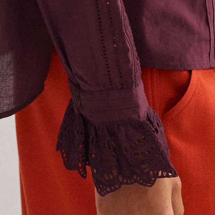 The full-length sleeves fall to detailed lace cuffs.