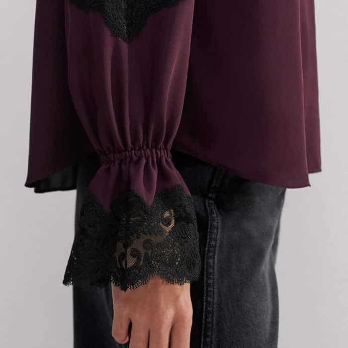 The long sleeves fall to lace cuffs with elasticated detailing to keep pushed-up sleeves in place.