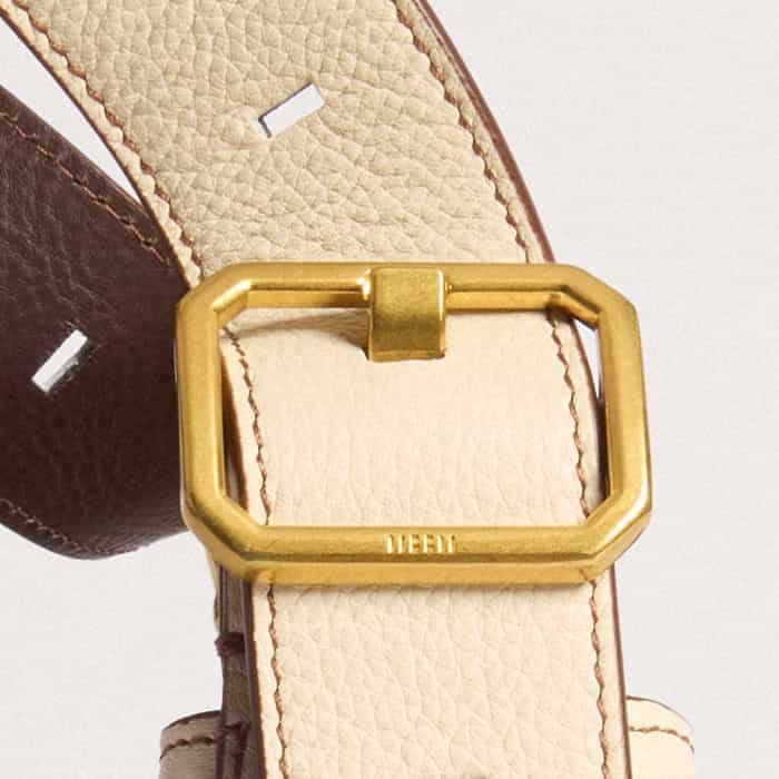 The buckle is elevated with ME+EM block branding.