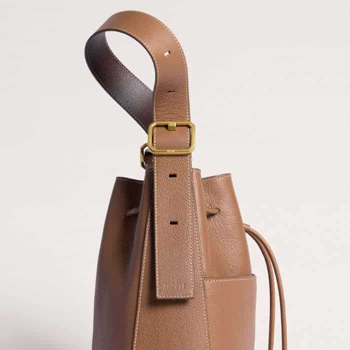 Crafted from Italian leather, the shoulder strap can be lengthened for carrying ease.