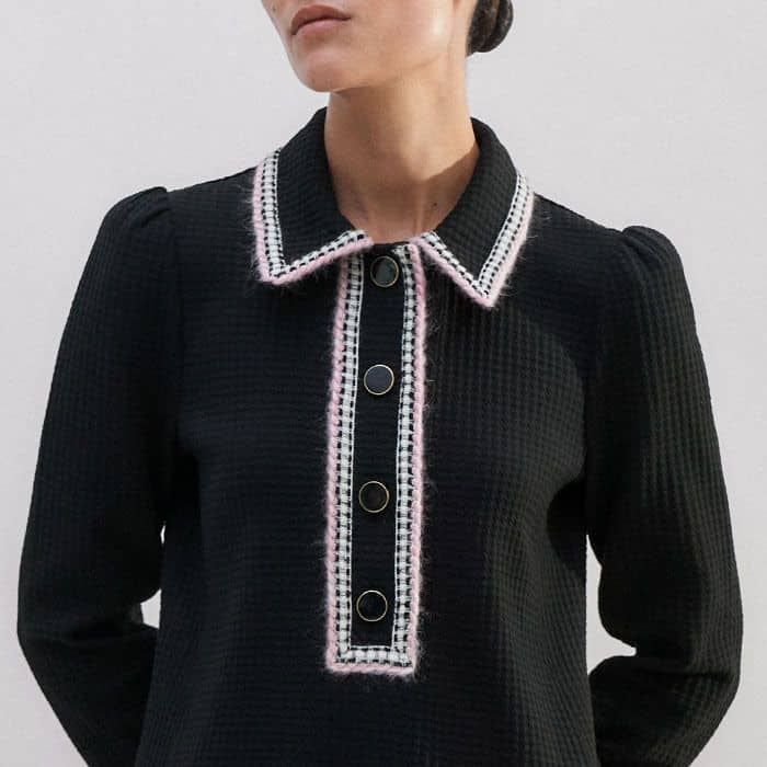 Oversized buttons at the neckline can be left undone to achieve a more relaxed finish.