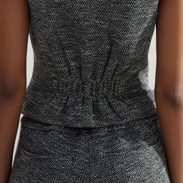 An elasticated panel at the back of the piece cinches in your waist for a flattering fit.