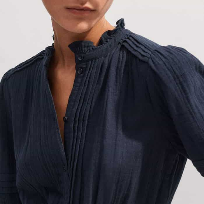 The buttoned front can be adjusted to alter the amount of coverage at the neckline.