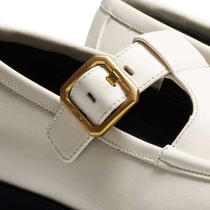 The adjustable gold-plated buckle is elevated with ME+EM block branding.