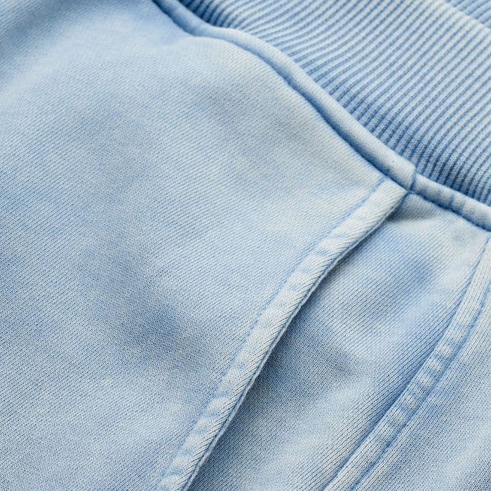 Crafted from a mid-weight cotton loopback sweatshirting jersey with good shape retention and a soft handfeel. This piece is treated with a retrodye and fade-out treatment for a washed effect. 