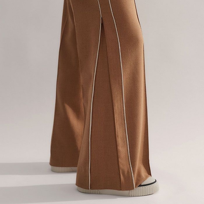 A zip at the side seam converts the shape from a straight leg to a wide leg silhouette.