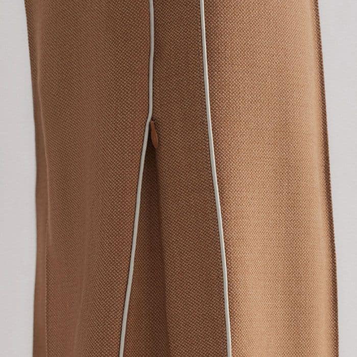 A zip at the side seam converts the shape from a straight leg to a wide leg silhouette.