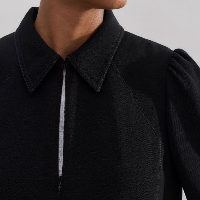 The zip fastening at the neckline allows for a customisable finish.