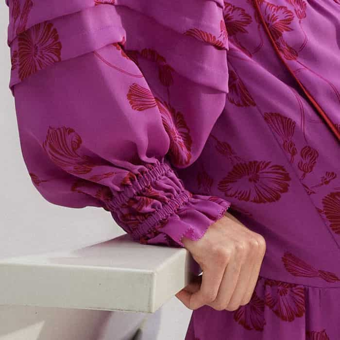 The balloon sleeves fall to shirred cuffs to keep pushed-up sleeves in place and to maintain their voluminous shape.