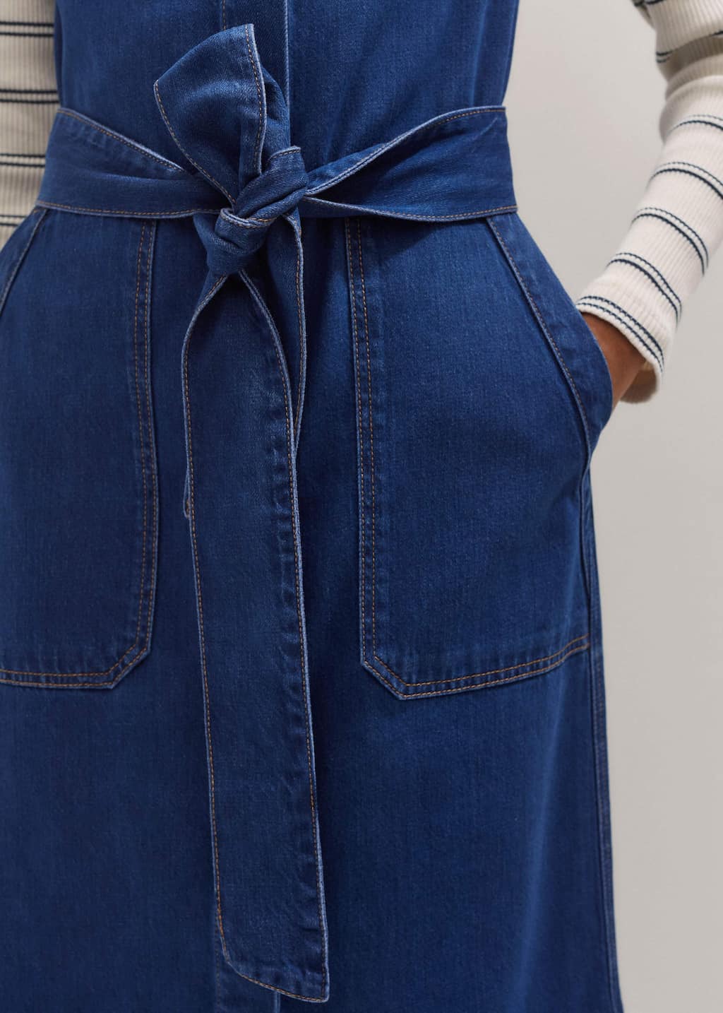 Four front pockets add functionality to the piece.