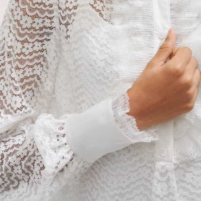 The lace sleeves fall to opaque fitted cuffs to keep pushed-up sleeves in place.