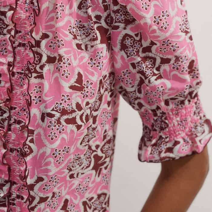 The short balloon sleeves fall to shirred cuffs for a voluminous finish.