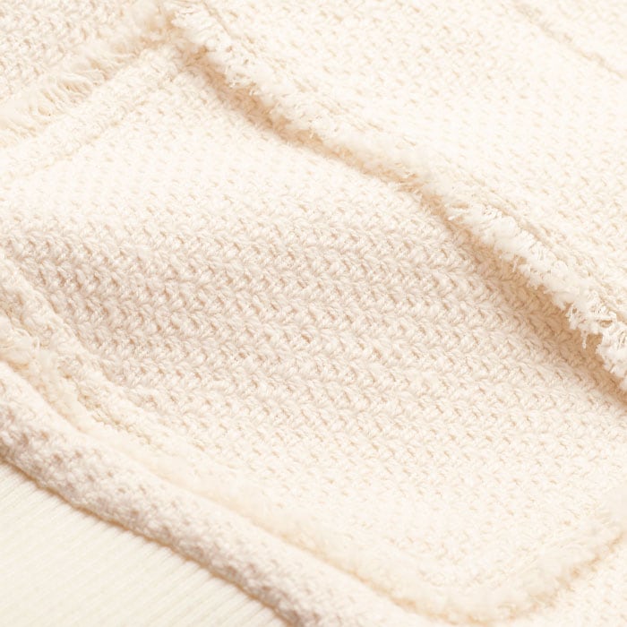 Crafted from cotton-blend textured fabric with a bouclé rib for a tactile finish.