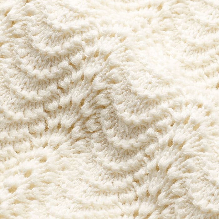 Crafted from high-twist cotton with a soft hand feel, clean finish and breathability for warmer months. Chunky 5gg knit in a scalloped lace stitch. Natural, breathable yarn.