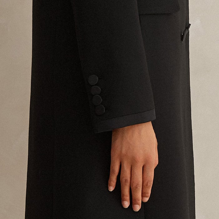 Four buttons line up alongside the length of the deep cuffs.