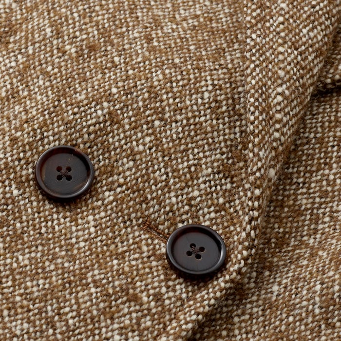 Italian tweed textured fabric with suede by-product elbow patch and melton undercollar detailing.