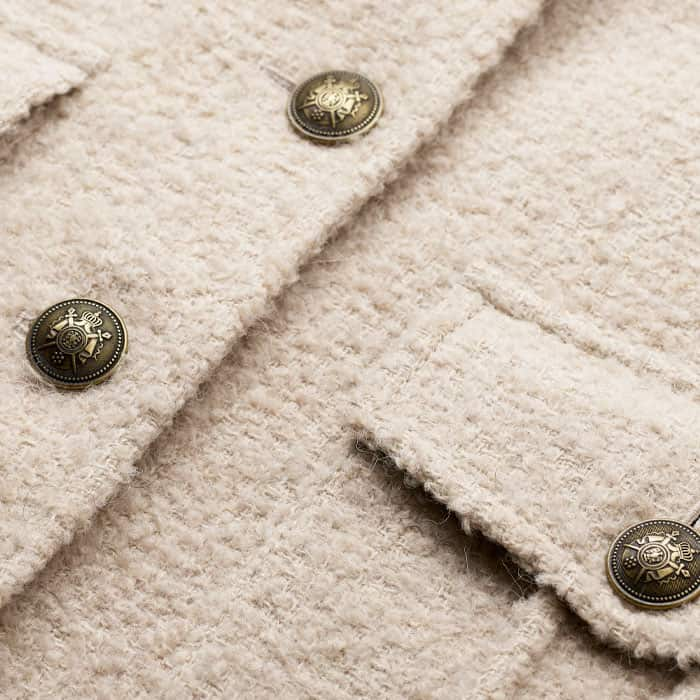 Crafted from a blended-fibre bouclé with a soft brushed surface. 