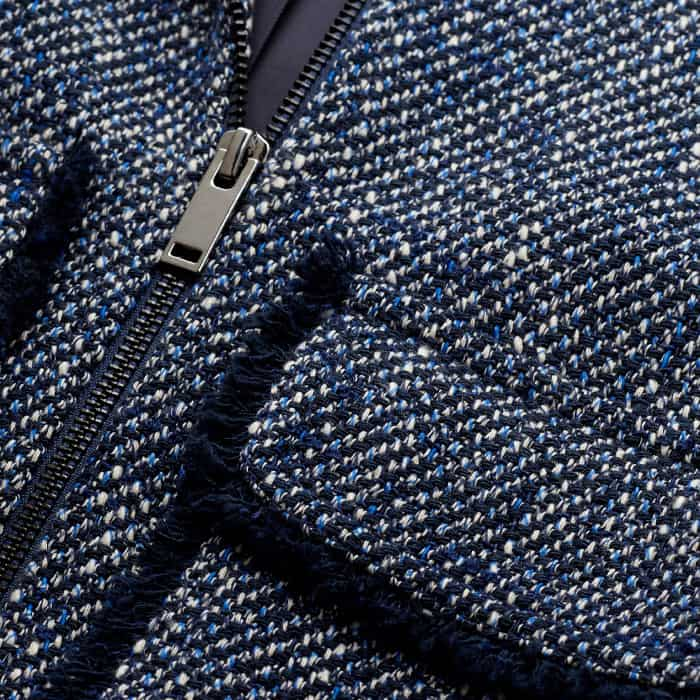 Crafted from an Italian cotton-blend tweed with contrasting white threads. This fabric has a textured surface so take care to avoid snagging. 