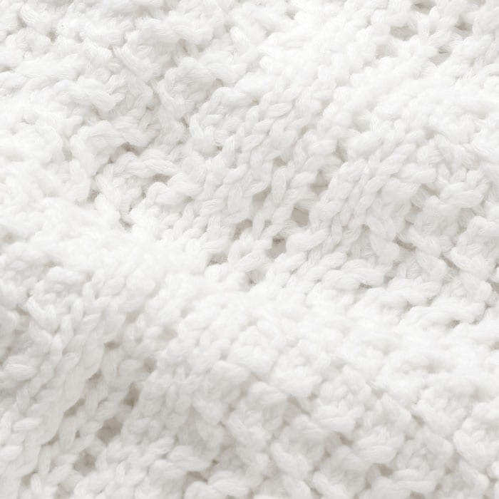 With a dry but soft hand feel, this cotton piece is knitted in a chunky open lace stitch with ribbed trims.