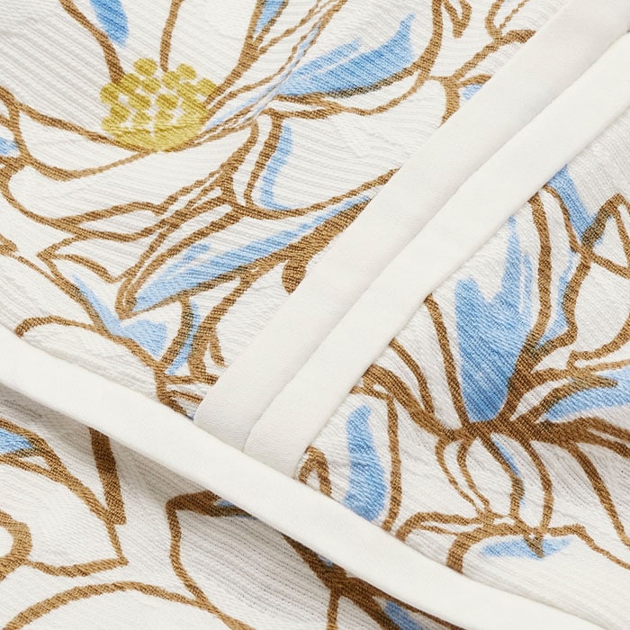 Breathable and structured, this cotton blend fabric features a jacquard design that creates texture and depth within the bespoke Linear floral print.