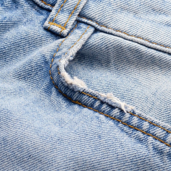 Crafted from Italian cotton denim with a frayed hem for an authentic finish.