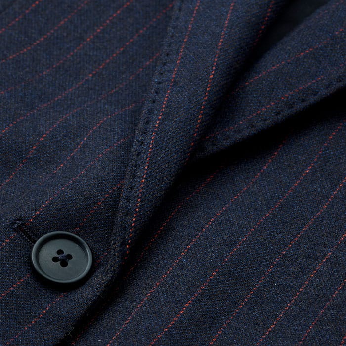 Made from Italian wool, viscose and recycled fibre-blend tailoring fabric with a subtly brushed surface and orange pinstripes.