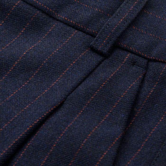 Made from Italian wool, viscose and recycled fibre-blend tailoring fabric with a subtly brushed surface and orange pinstripes.