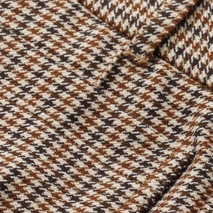 Crafted from a stretch-infused wool blend, patterned with a neutral-toned houndstooth check.